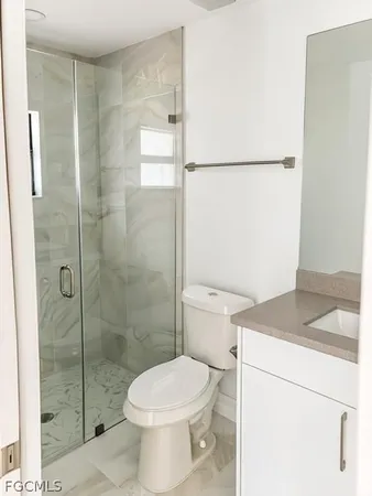 a white toilet sitting next to a bathroom sink