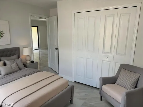 a bedroom with a bed and a couch