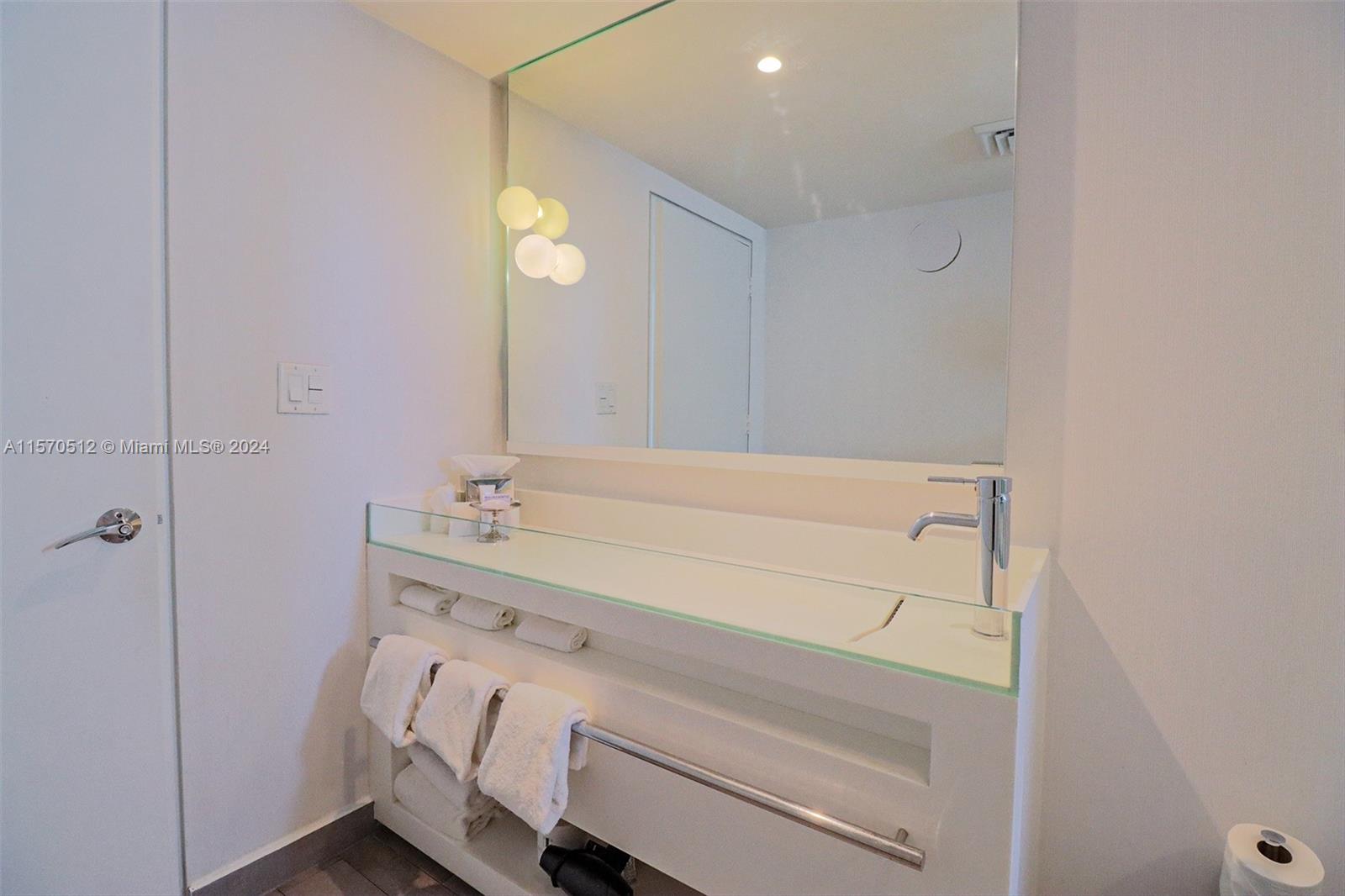 1100 West Avenue, Unit 816 Miami Beach, FL 33139 - Photo 13 of 22 a bathroom with a sink and a mirror