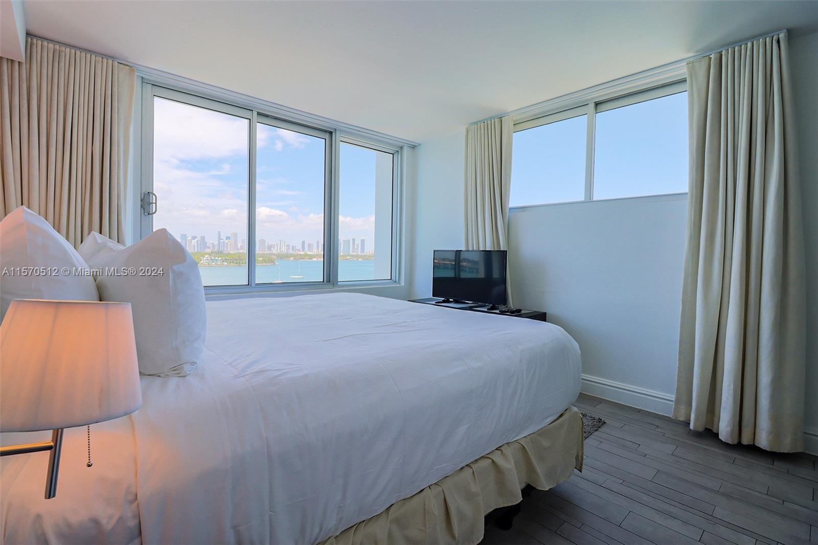 1100 West Avenue, Unit 816 Miami Beach, FL 33139 - Photo 14 of 22 a bedroom with a bed and a large window