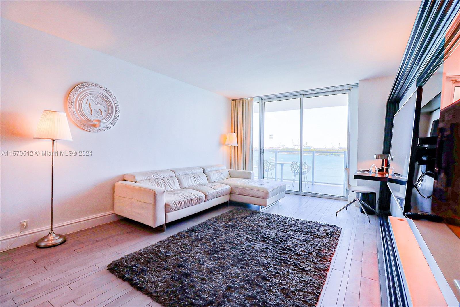 1100 West Avenue, Unit 816 Miami Beach, FL 33139 - Photo 2 of 22 a living room with furniture and a rug