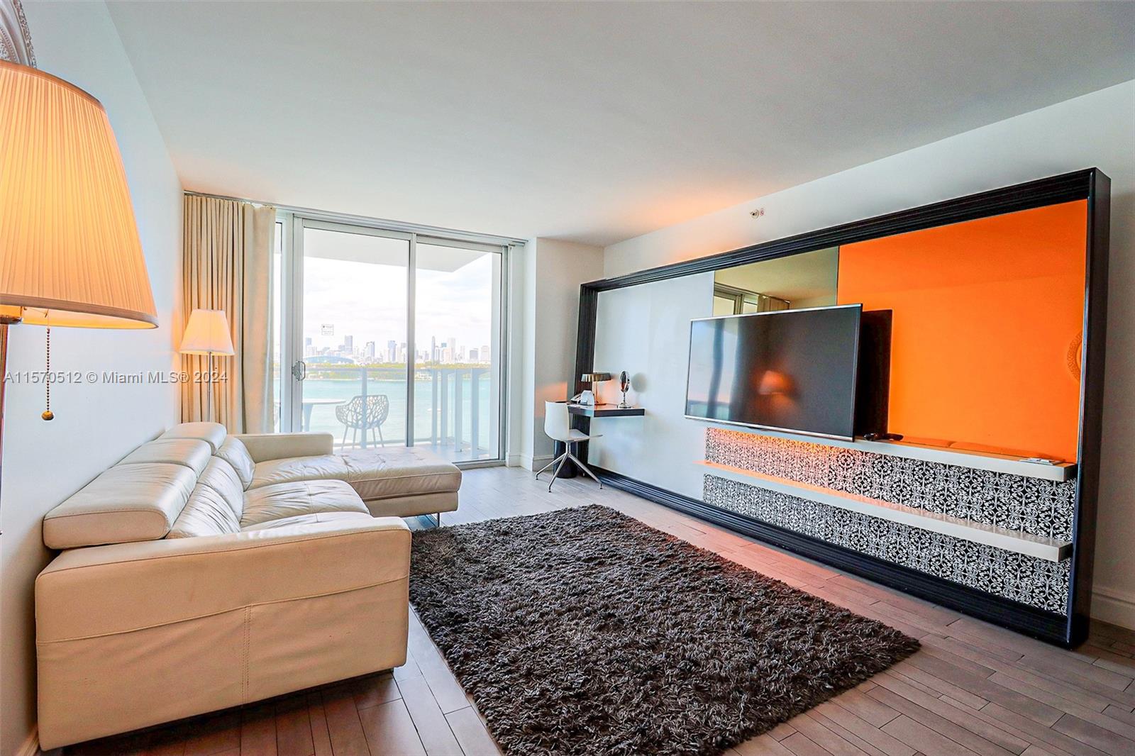 1100 West Avenue, Unit 816 Miami Beach, FL 33139 - Photo 3 of 22 a living room with furniture and a flat screen tv
