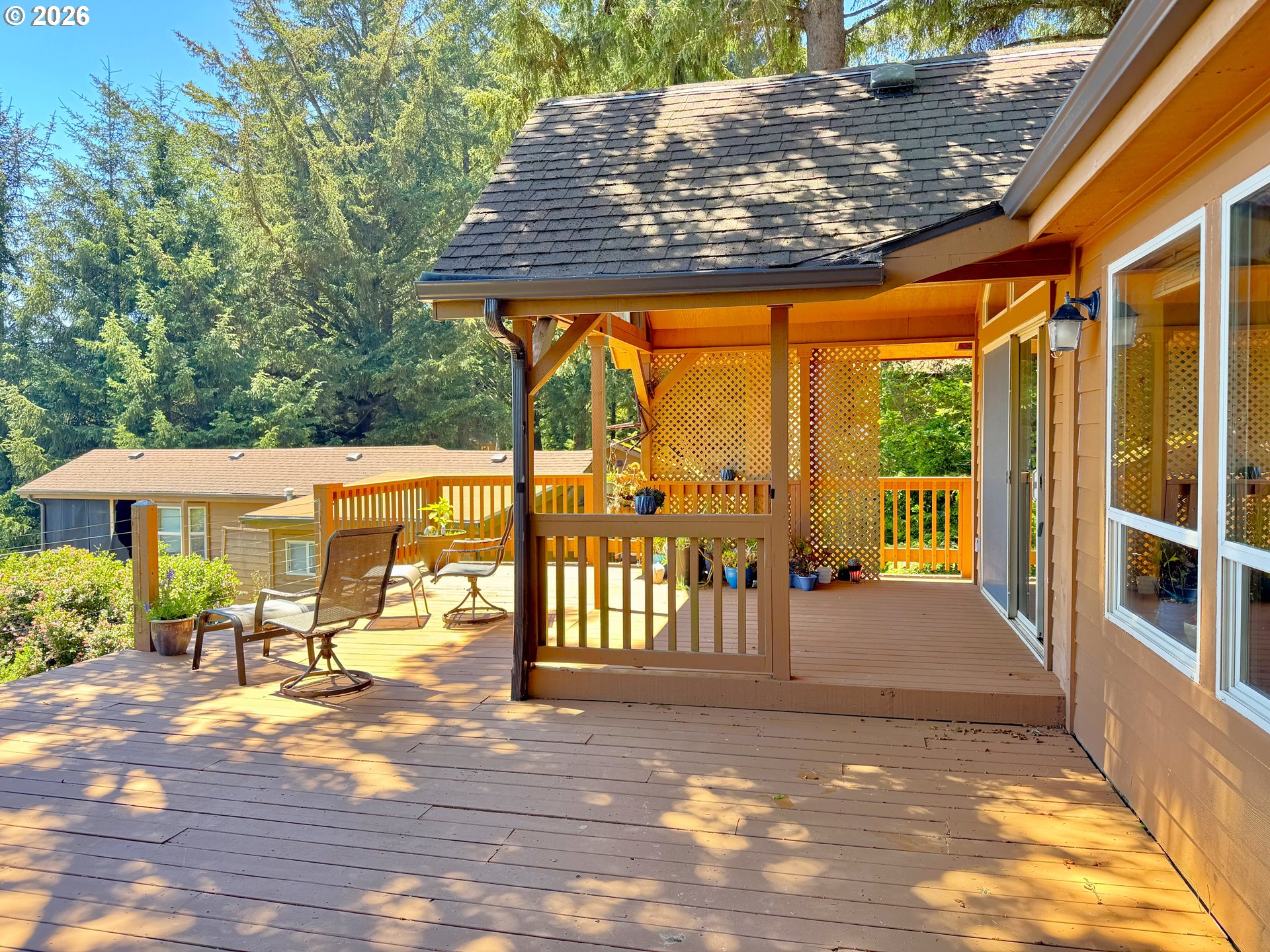 19921 Whaleshead Road, Unit U25 Brookings, OR 97415 - Photo 11 of 47 a view of a patio with table and chairs potted plants with wooden floor and fence