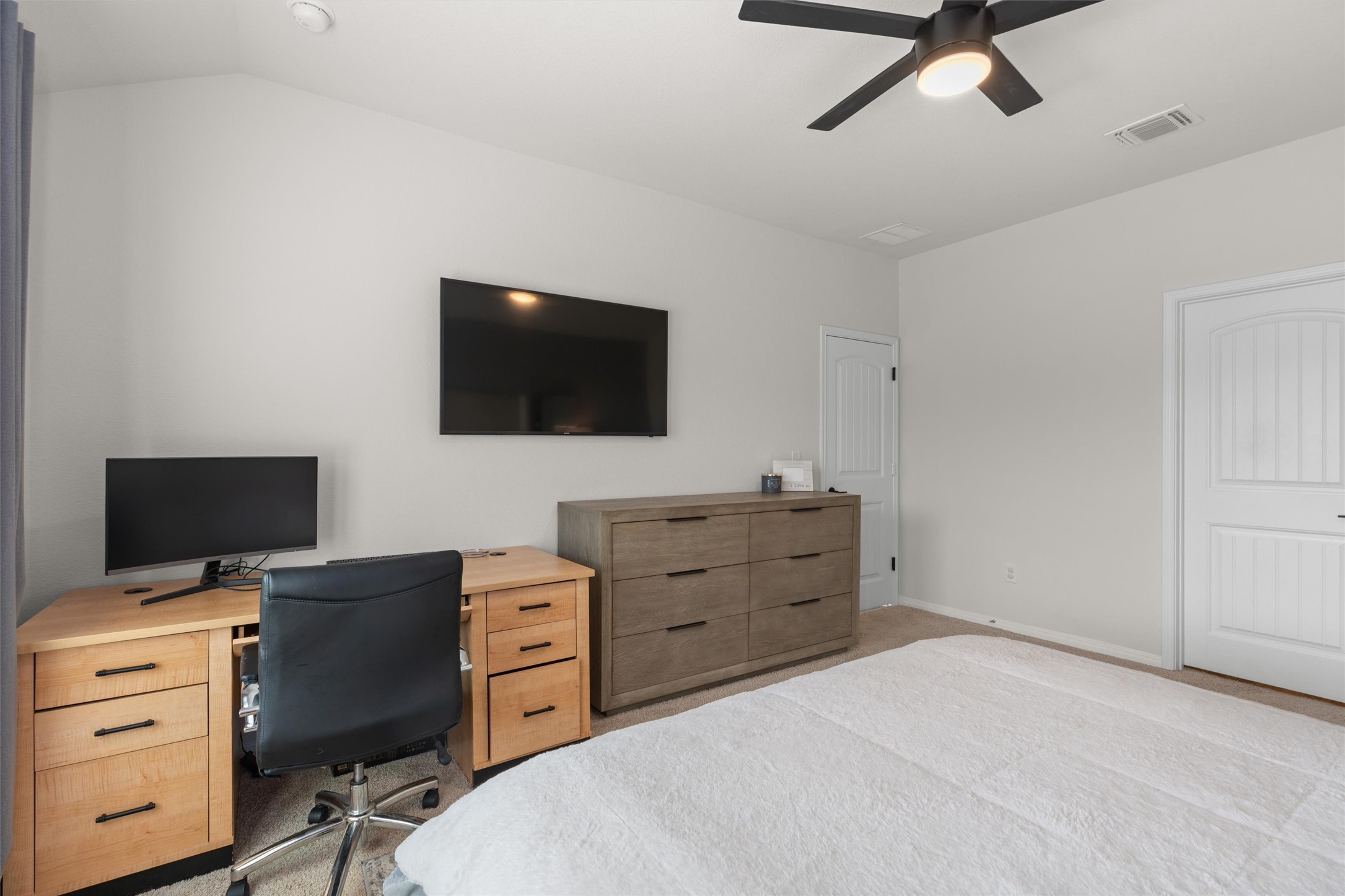19912 Abigail Fillmore Road Manor, TX 78653 - Photo 13 of 31 Carpeted bedroom with a vaulted ceiling and a cooling ceiling fan.