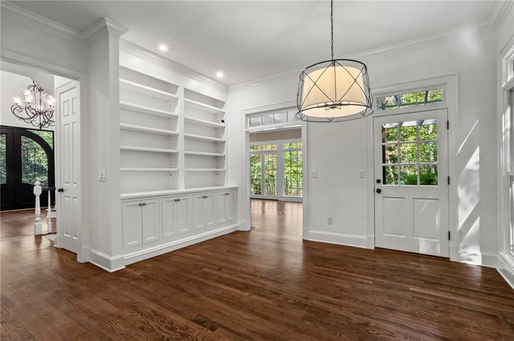 1235 West Garmon Road Northwest Atlanta, GA 30327 - Photo 13 of 46 a view of empty room with wooden floor and fan