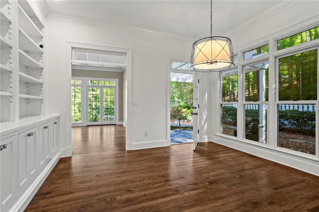 1235 West Garmon Road Northwest Atlanta, GA 30327 - Photo 14 of 46 a view of a room with wooden floor chandelier and glass door