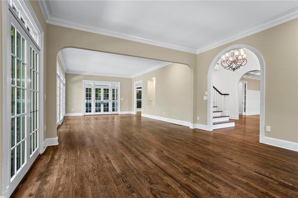 1235 West Garmon Road Northwest Atlanta, GA 30327 - Photo 17 of 46 a view of an empty room with wooden floor and a window