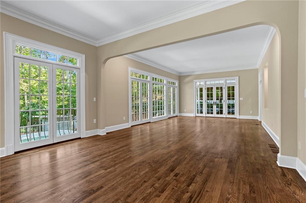 1235 West Garmon Road Northwest Atlanta, GA 30327 - Photo 18 of 46 a view of an empty room with wooden floor and a window