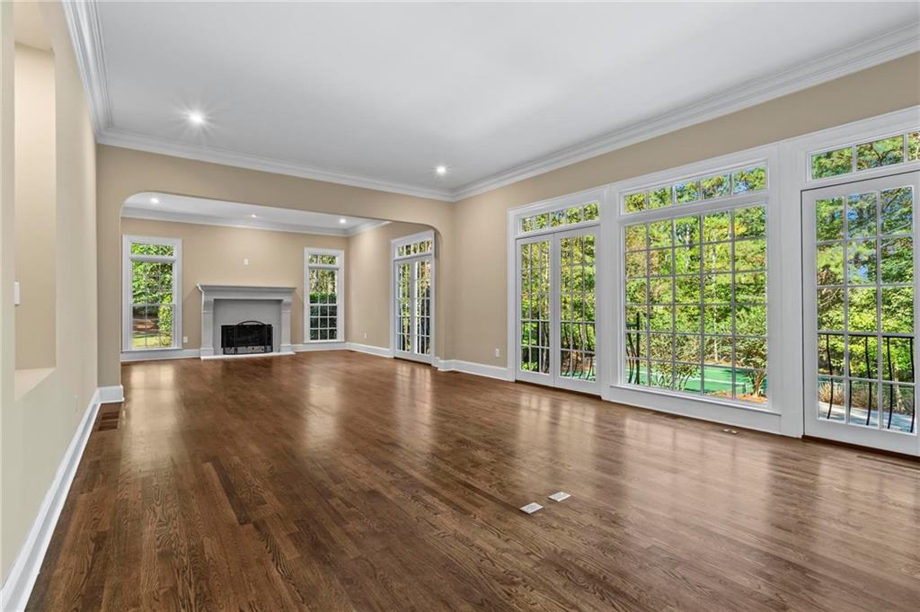 1235 West Garmon Road Northwest Atlanta, GA 30327 - Photo 19 of 46 a view of an empty room with wooden floor and a window