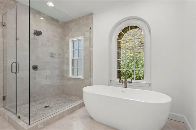 a white bath tub sitting next to a window