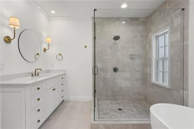 a bathroom with a double vanity sink a toilet a mirror and shower