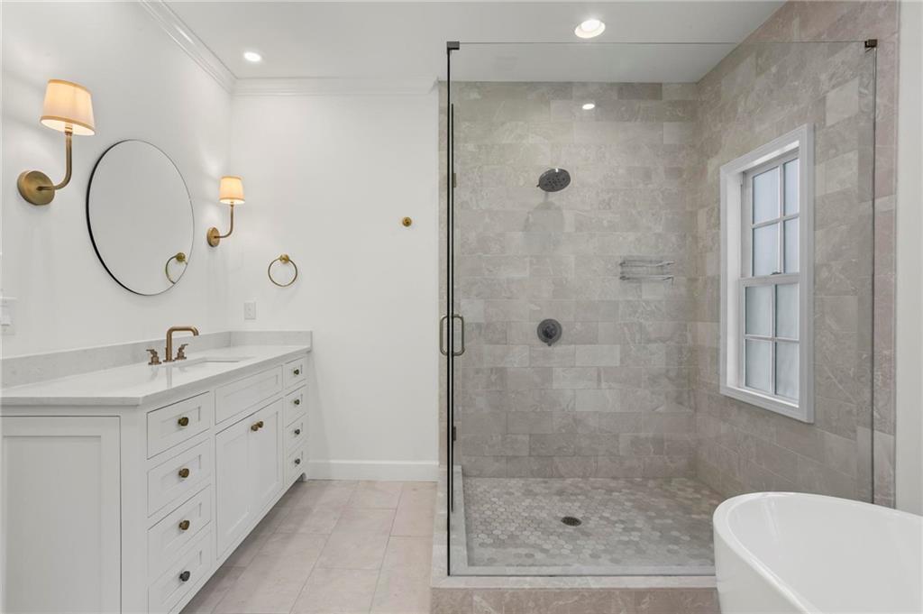 1235 West Garmon Road Northwest Atlanta, GA 30327 - Photo 24 of 46 a bathroom with a double vanity sink a toilet a mirror and shower