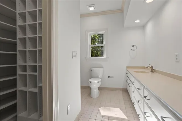 a spacious bathroom with a double vanity sink a toilet and a window