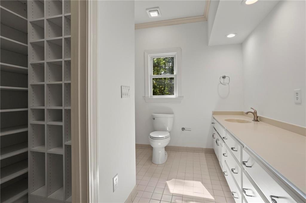 1235 West Garmon Road Northwest Atlanta, GA 30327 - Photo 29 of 46 a spacious bathroom with a double vanity sink a toilet and a window