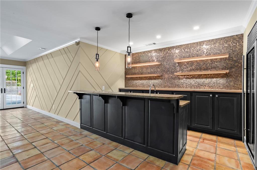1235 West Garmon Road Northwest Atlanta, GA 30327 - Photo 34 of 46 a kitchen with kitchen island granite countertop a sink a counter top space and cabinets