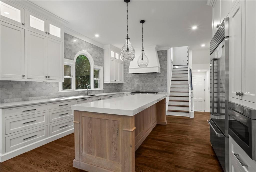 1235 West Garmon Road Northwest Atlanta, GA 30327 - Photo 6 of 46 a kitchen with kitchen island granite countertop a stove and a sink