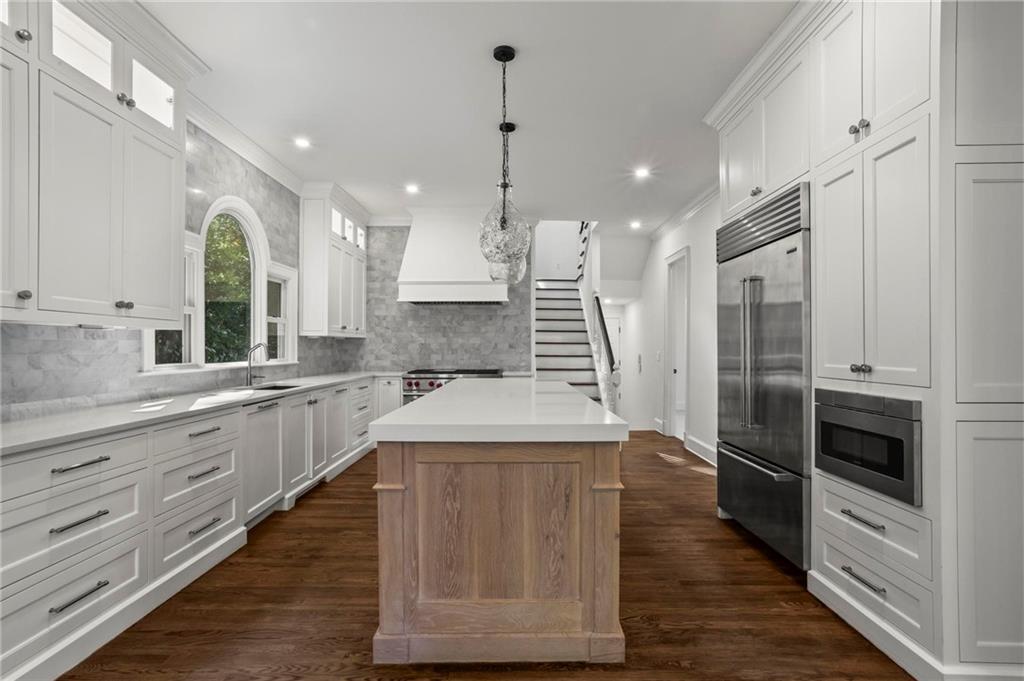 1235 West Garmon Road Northwest Atlanta, GA 30327 - Photo 7 of 46 a large kitchen with stainless steel appliances kitchen island granite countertop a stove a sink and a refrigerator