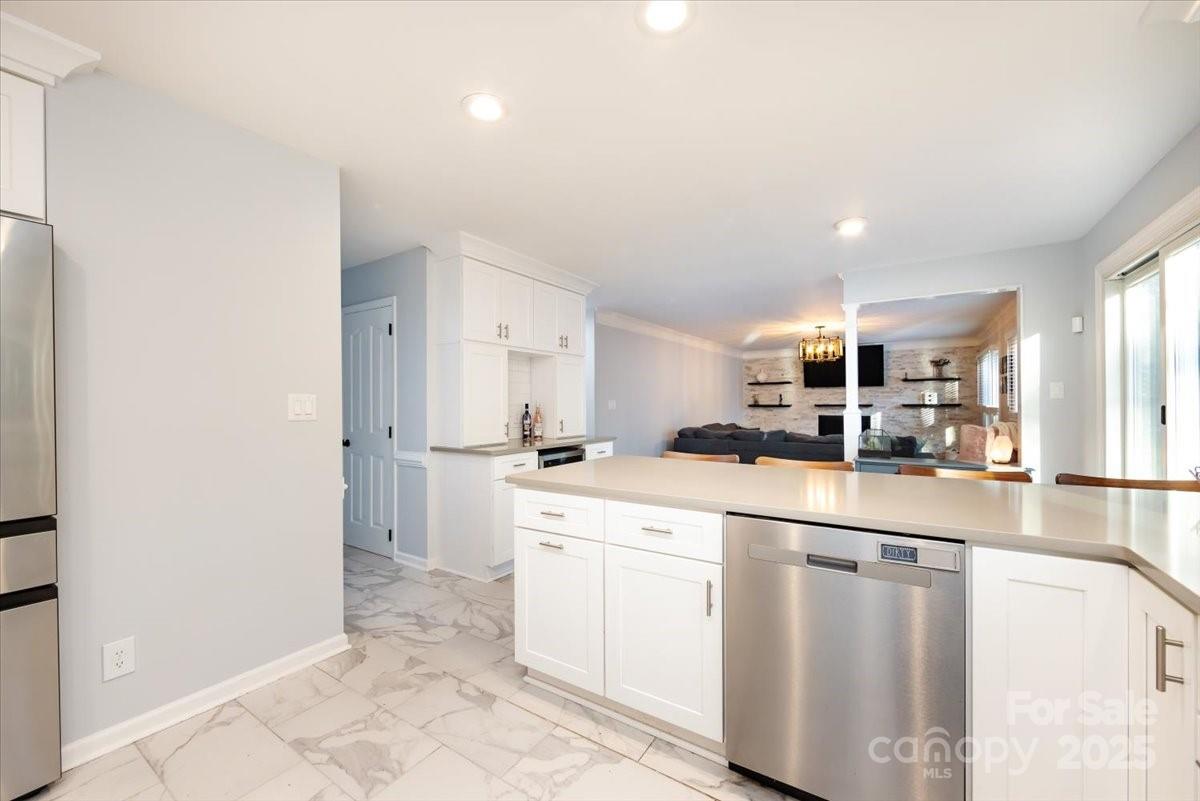 10937 Back Ridge Road Charlotte, NC 28277 - Photo 18 of 45 a kitchen with white cabinets and sink
