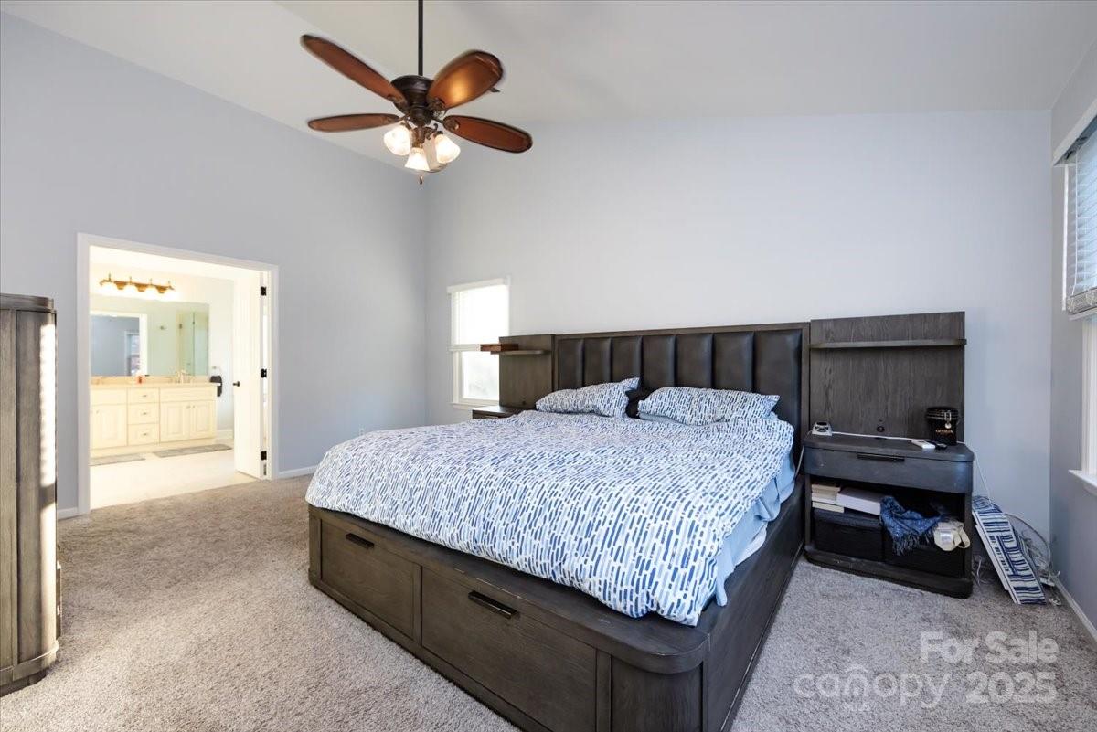 10937 Back Ridge Road Charlotte, NC 28277 - Photo 23 of 45 a bedroom with a bed and a chandelier