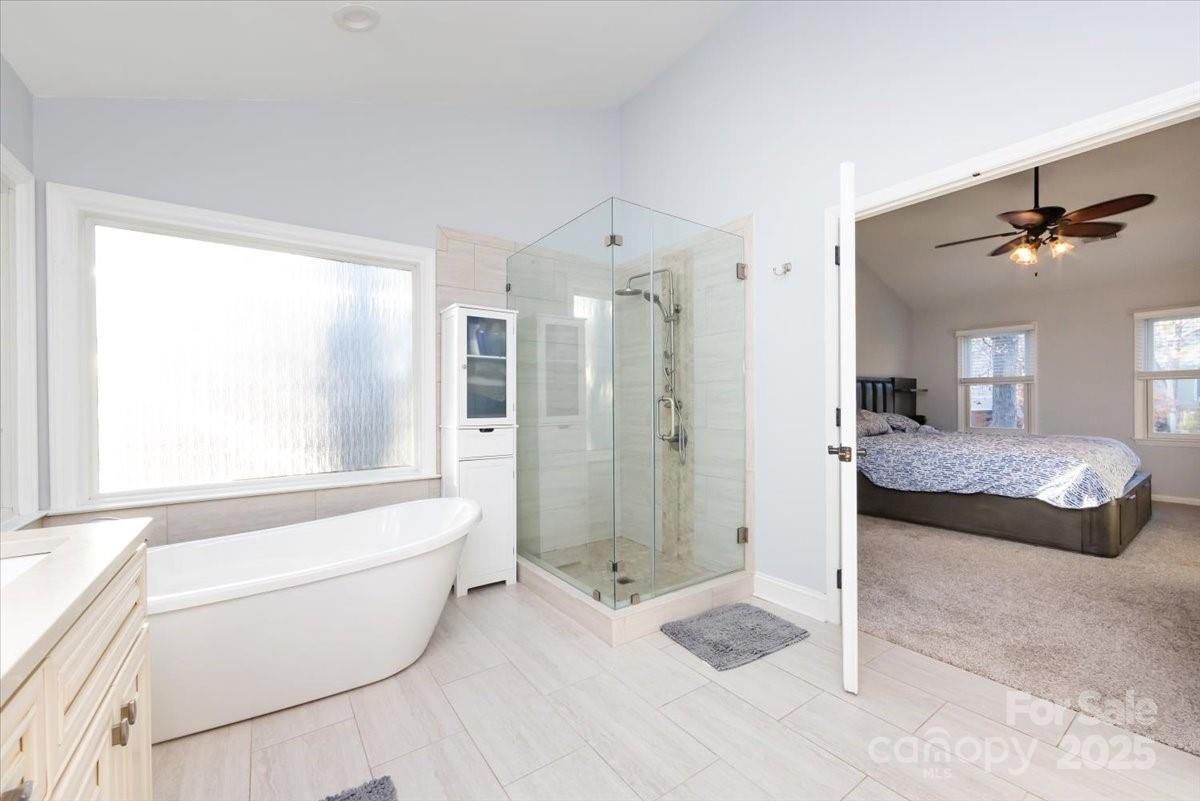 10937 Back Ridge Road Charlotte, NC 28277 - Photo 26 of 45 a spacious bathroom with a granite countertop tub sink and a shower