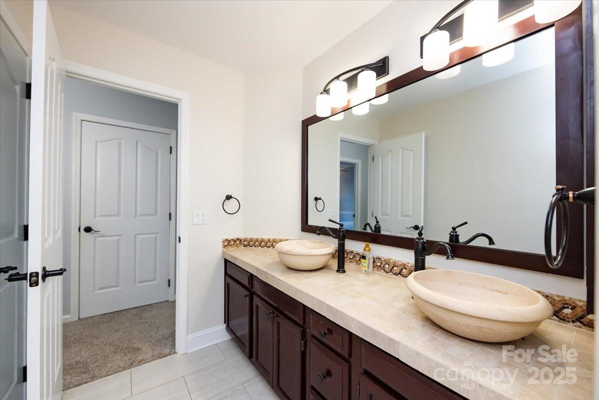 10937 Back Ridge Road Charlotte, NC 28277 - Photo 31 of 45 a bathroom with a granite countertop sink and a mirror
