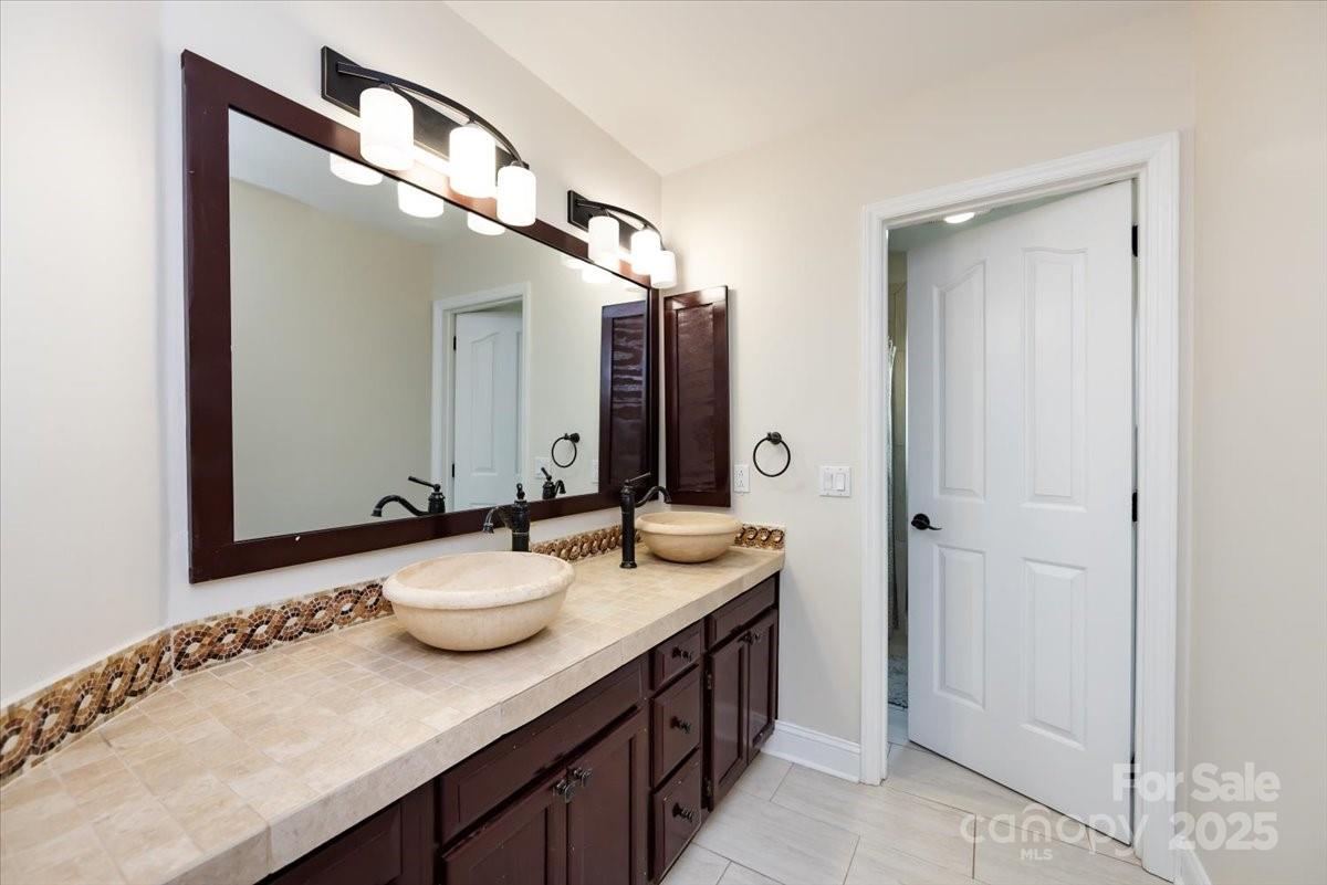 10937 Back Ridge Road Charlotte, NC 28277 - Photo 32 of 45 a bathroom with a granite countertop sink and a mirror