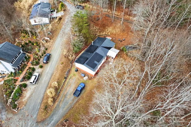 an aerial view of a house with a yard and trees