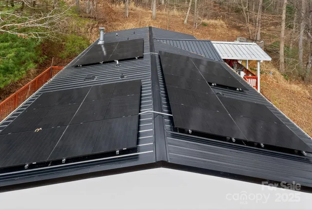 a white house that has a tree in front of it