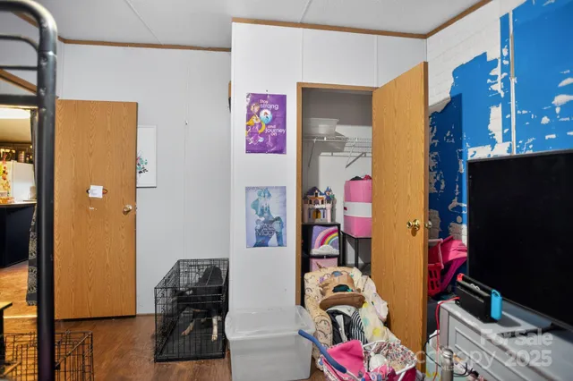 a bedroom with a bed and a flat screen tv