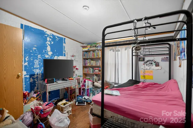 a bedroom with bed and dresser