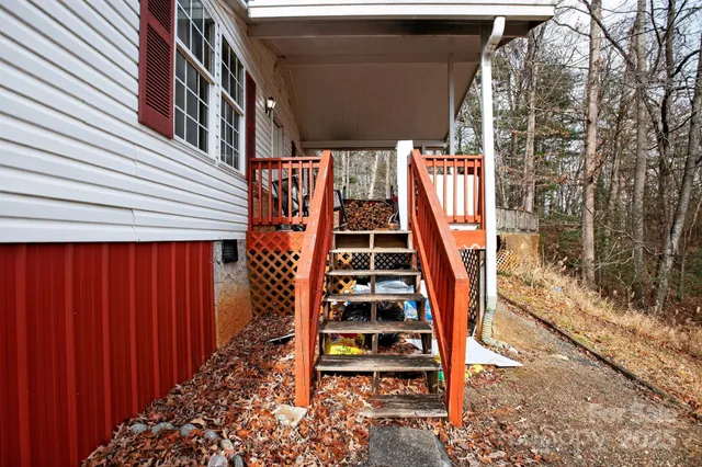 a view of a house with a yard and wooden floor and fence