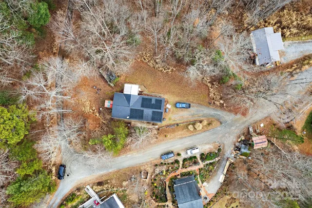 a view of house with a deck and a yard
