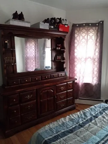 a view of room with wooden floor and a cabinet