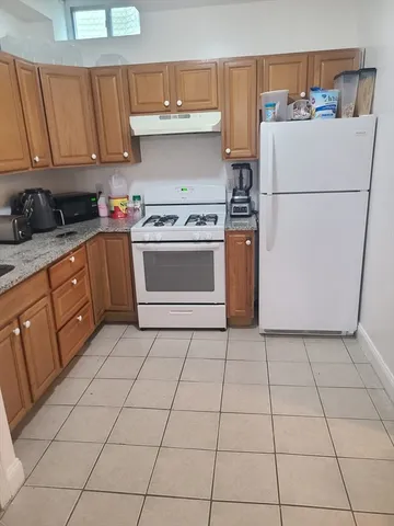 a kitchen with a cabinets and a stove top oven