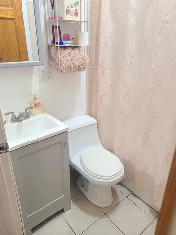 a bathroom with a sink toilet and mirror