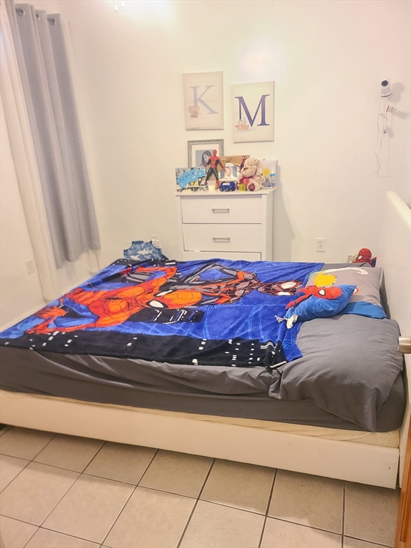 455 Washington Street Haverhill, MA 01832 - Photo 28 of 29 a bedroom with a bed and book shelf