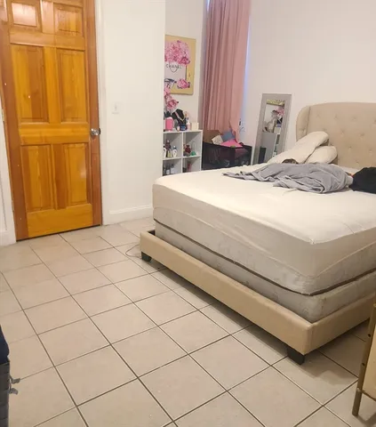 a bedroom with a bed and a mirror