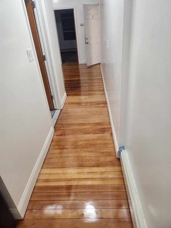 455 Washington Street Haverhill, MA 01832 - Photo 5 of 29 a view of a hallway with wooden floor and staircase
