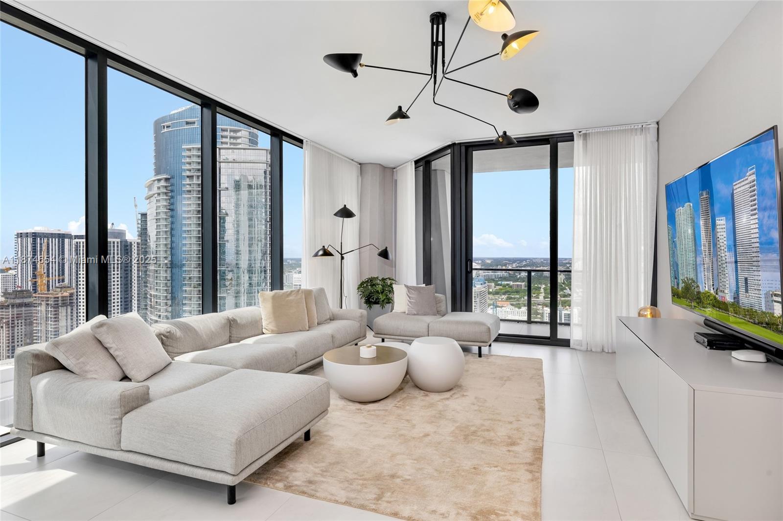 1000 Biscayne Boulevard, Unit 3801 Miami, FL 33132 - Photo 12 of 31 a living room with furniture and a large window