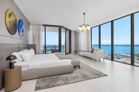 a living room with furniture and large windows