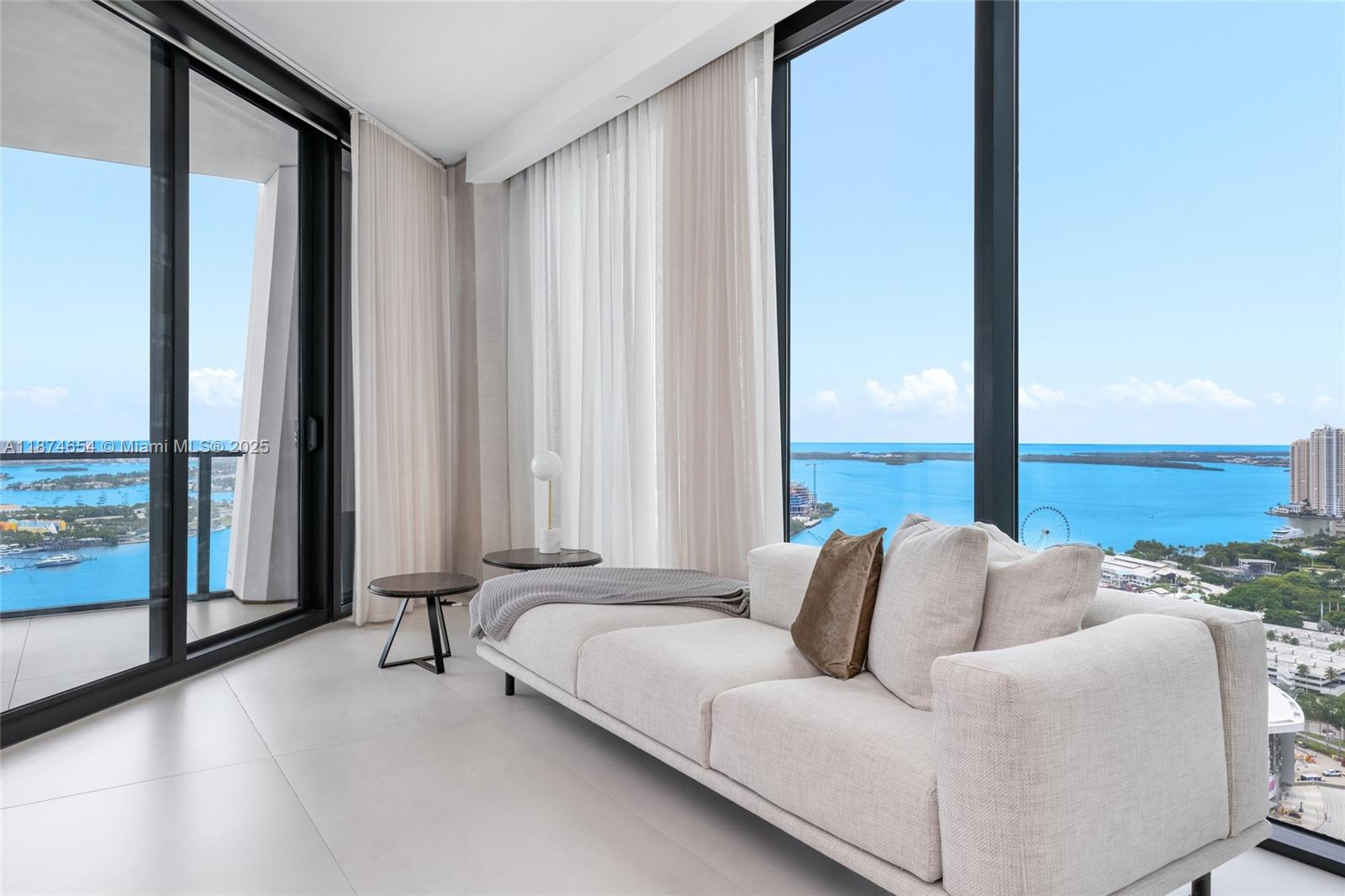 1000 Biscayne Boulevard, Unit 3801 Miami, FL 33132 - Photo 15 of 31 a living room with furniture and large windows