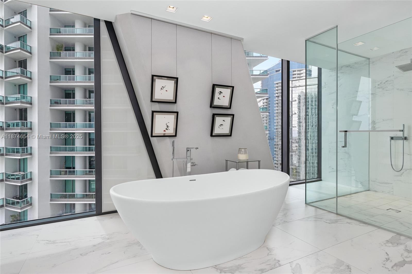 1000 Biscayne Boulevard, Unit 3801 Miami, FL 33132 - Photo 17 of 31 a bathroom with a bathtub and a shower