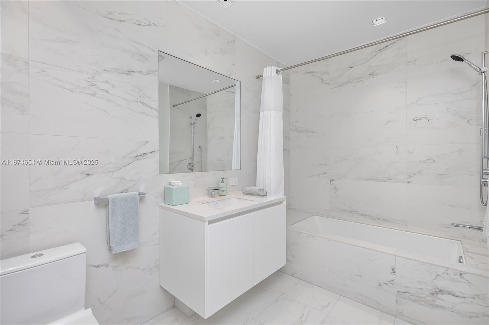 1000 Biscayne Boulevard, Unit 3801 Miami, FL 33132 - Photo 21 of 31 a bathroom with a sink a toilet and shower