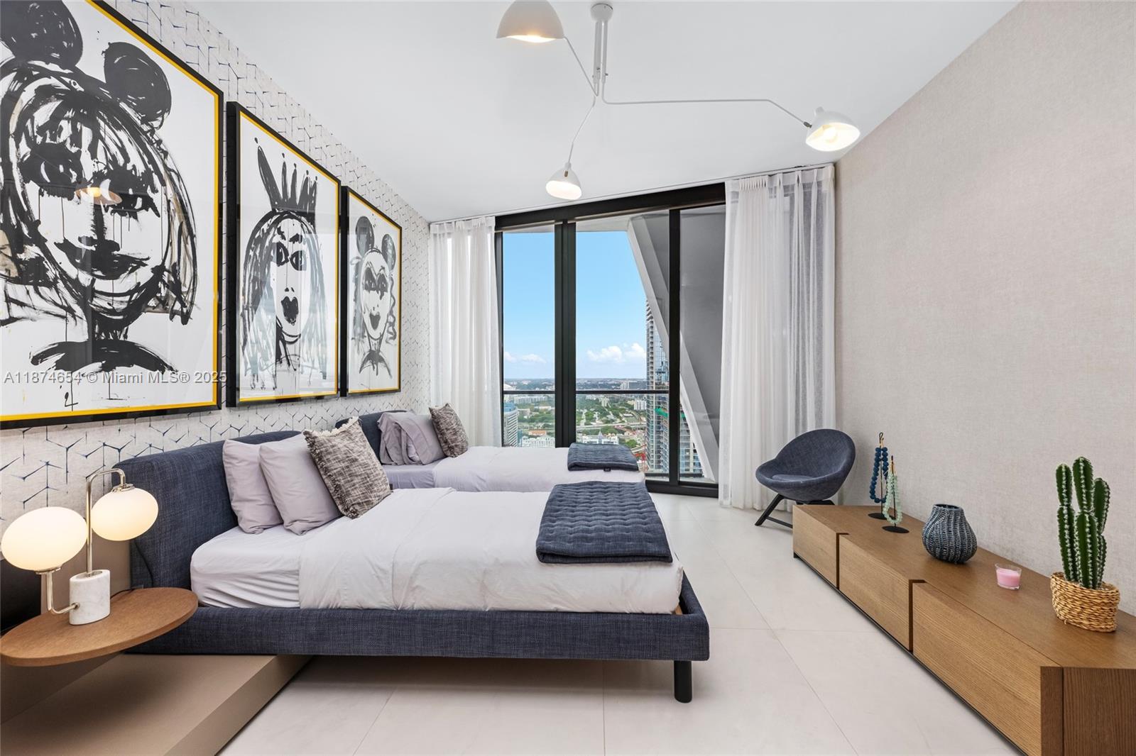 1000 Biscayne Boulevard, Unit 3801 Miami, FL 33132 - Photo 22 of 31 a spacious bedroom with a bed and glass window