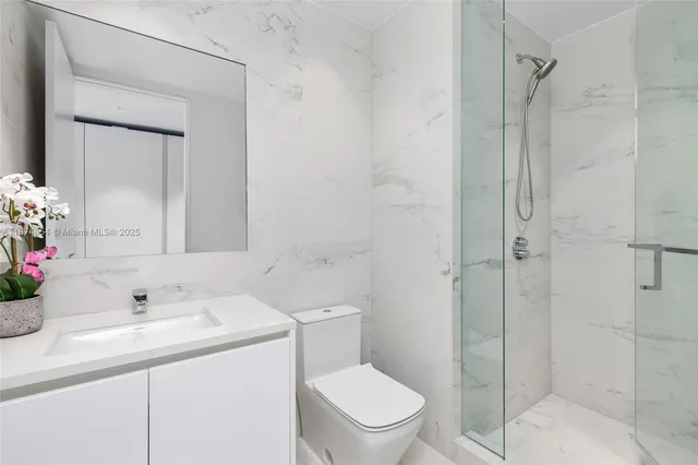 a bedroom with a bed and large windows