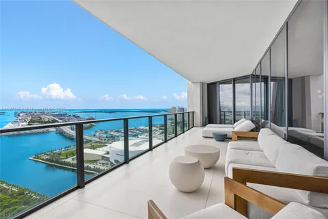a dining room with furniture and a large window