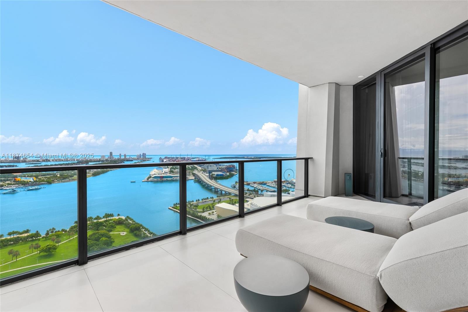 1000 Biscayne Boulevard, Unit 3801 Miami, FL 33132 - Photo 25 of 31 a bedroom with a bed and large windows