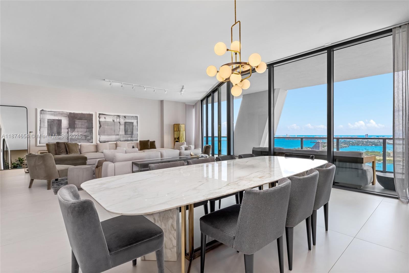 1000 Biscayne Boulevard, Unit 3801 Miami, FL 33132 - Photo 6 of 31 a view of a dining room and livingroom with furniture wooden floor a chandelier
