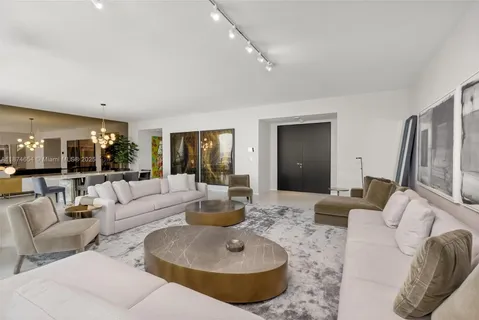 a living room with furniture and a large mirror