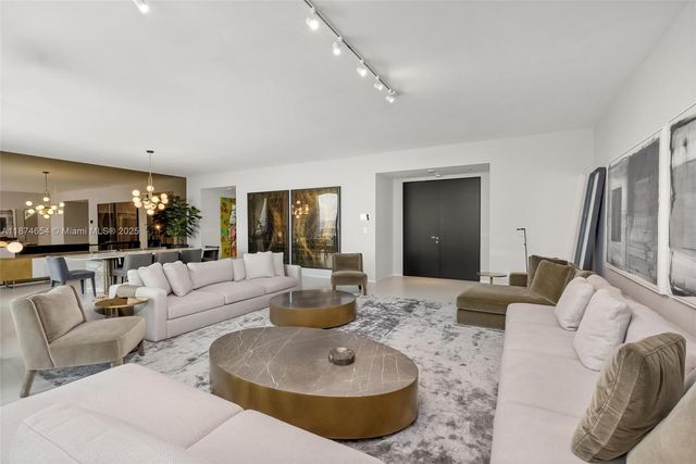 a living room with furniture and a large mirror